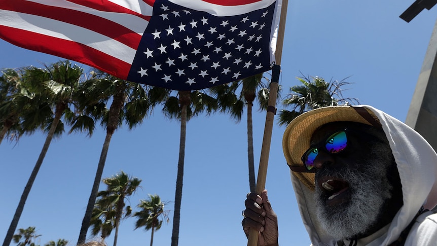 Homeless activist Ted Hayes in Venice Beach, CA, says he will fly the flag upside down until reforms are made. June 2020