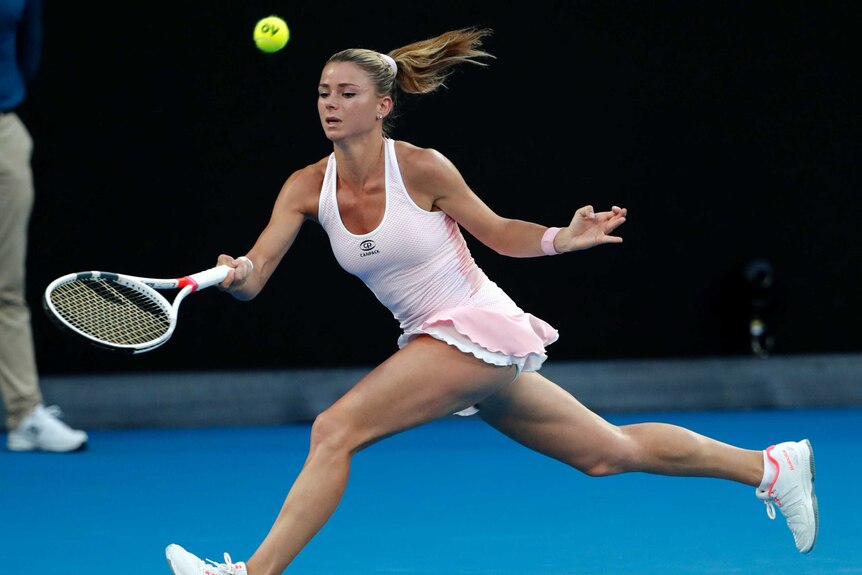 Camila Giorgi makes a forehand on the run against Ashleigh Barty at the Australian Open.