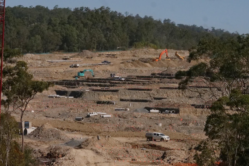 Large construction site with bushland in background