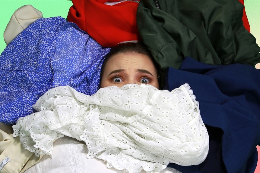Graphic: A woman with an anxious expression looks out from underneath a pile of clothes.