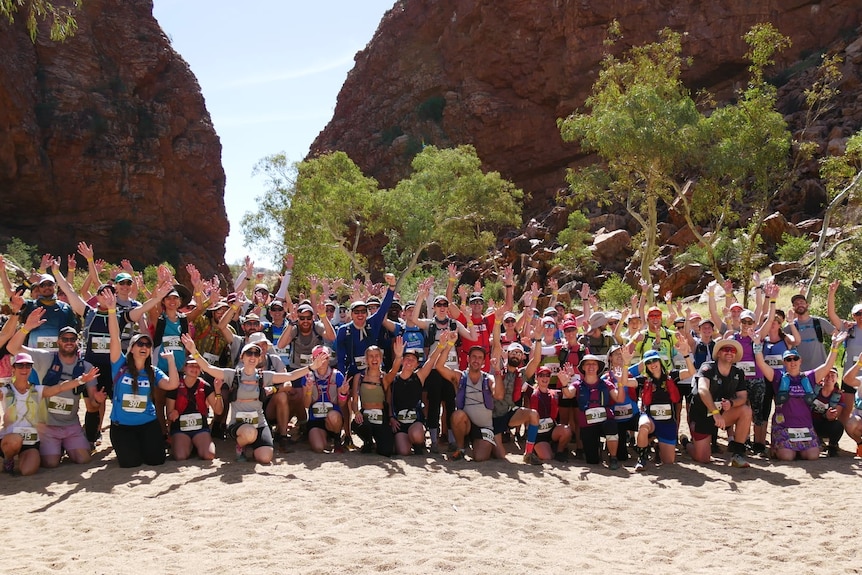 A group of runners pose for a photo. 