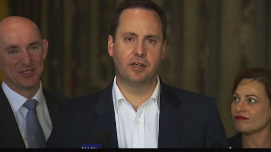 Federal MP Steven Ciobo speaking on light rail funding, watched by Deputy Premier Jackie Trad.