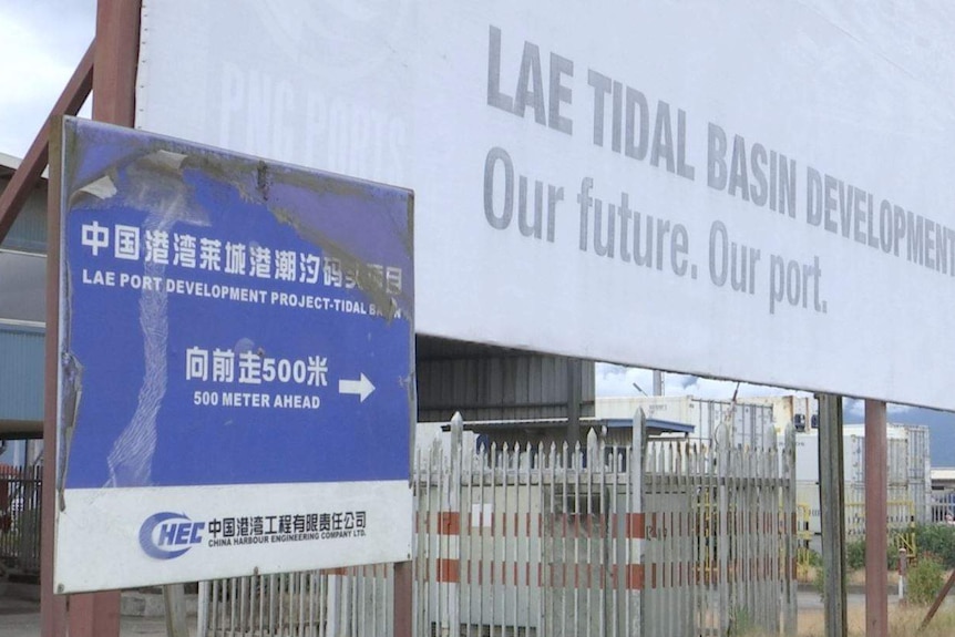 A blue sign points towards the Lae Tidal Basin Development in PNG.