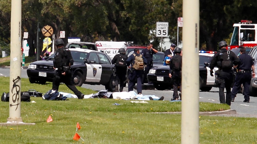 Police officers at the scene of a multiple death shooting in Oakland.