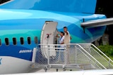 Refugee couple boarding a plane in Nauru