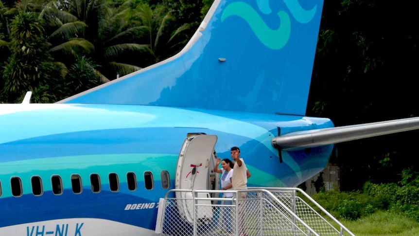 Refugee couple boarding a plane in Nauru