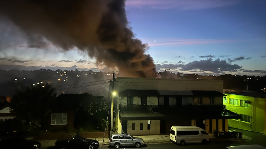Smoke from a fire in a warehouse as seen from a resident's balcony