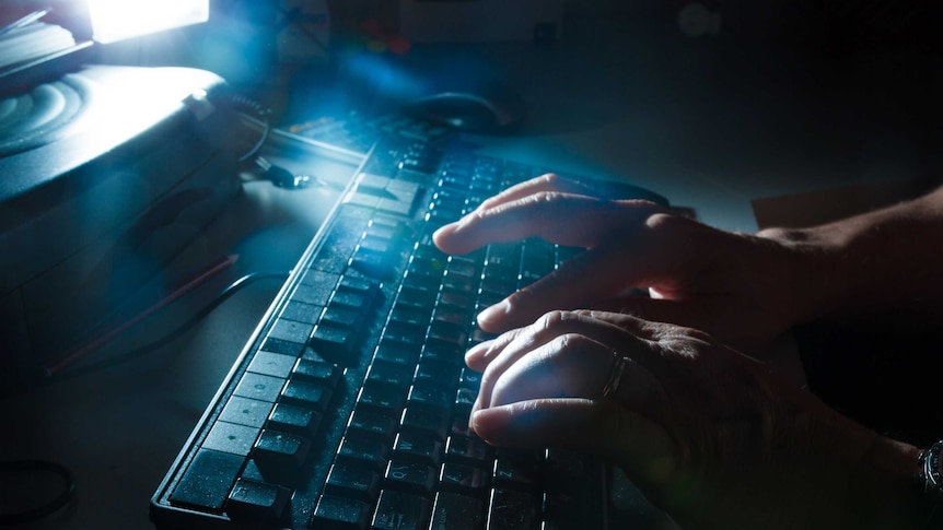 Anonymous male hands on a keyboard.