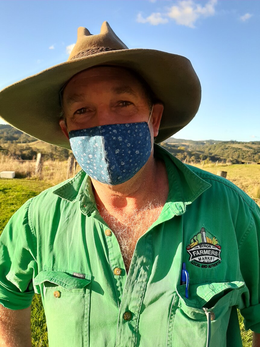 Tom Carey wearing a hat and a mask.