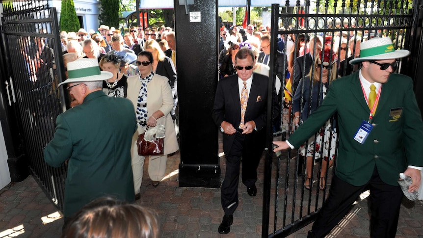 Punters rush in as the gates are opened at Flemington racecourse on Melbourne Cup day.