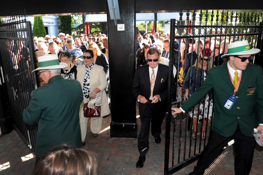 Punters rush in as the gates are opened at Flemington racecourse on Melbourne Cup day.
