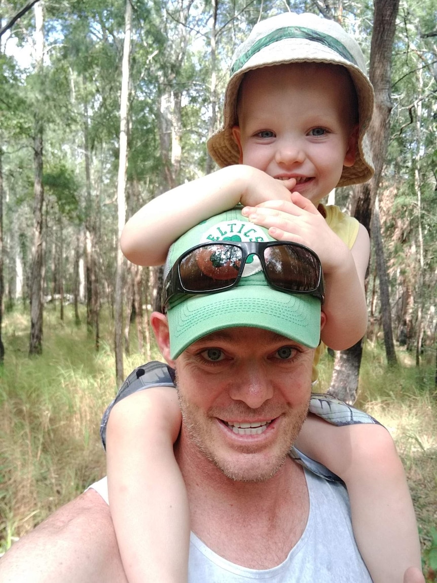 A photo of toddler Sonny on his dad's shoulders