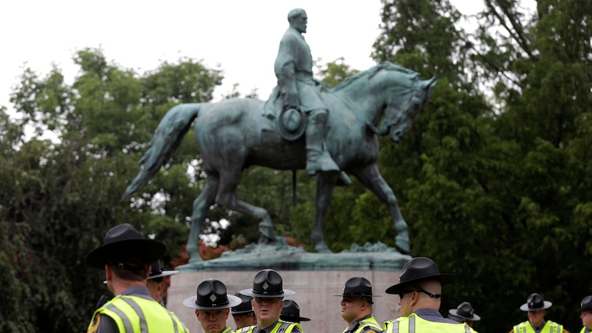 Police in front of a statue of Robert E Lee in Charlottesville