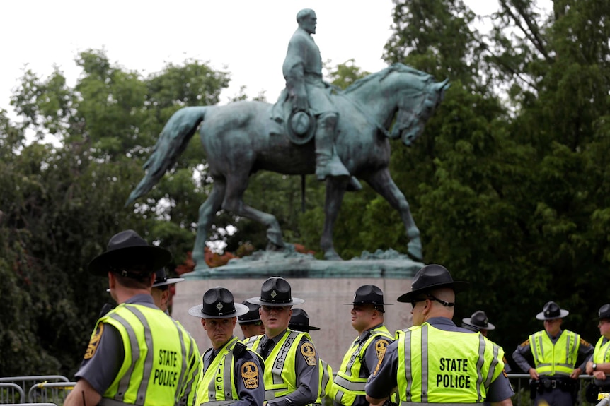 Police in front of a statue of Robert E Lee in Charlottesville