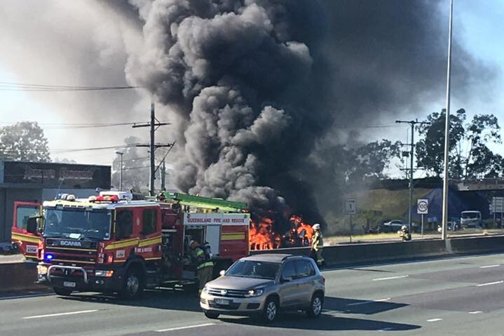 Truck on fire on the M1 at Logan, with firefighters at scene, south of Brisbane