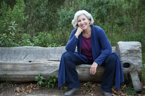 Ann Davidman sits on an outdoor log chair