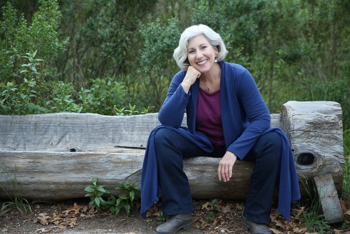 Ann Davidman sits on an outdoor log chair