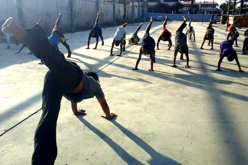 Jackson Manuai Kiap holds a yoga class in the remains of an old warehouse in Gordon, Port Moresby.