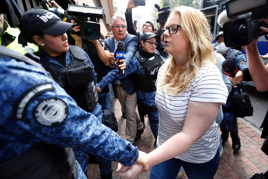 Australian Cassandra "Cassie" Sainsbury, 22, is escorted by police to a court hearing in Bogota.