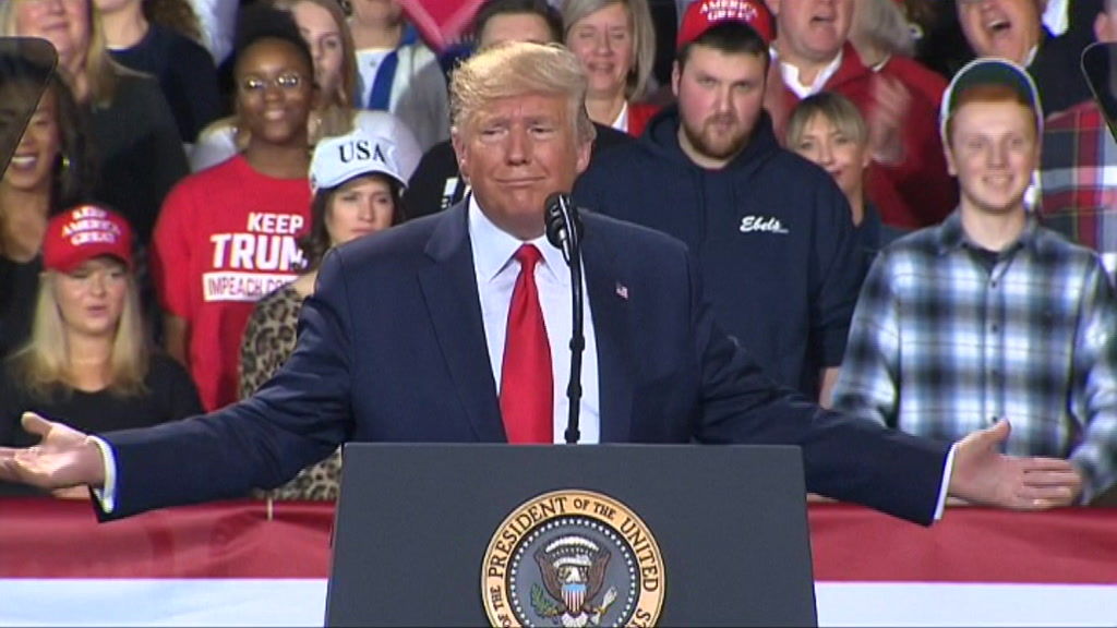 Donald Trump addresses a rally of supporters while the House hears ...