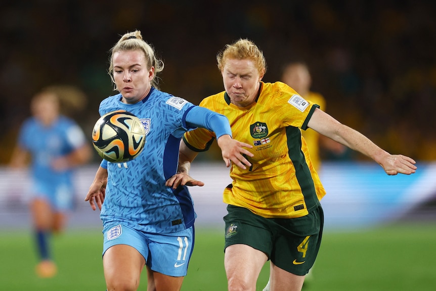 Lauren Hemp runs past Clare Polkinghorne