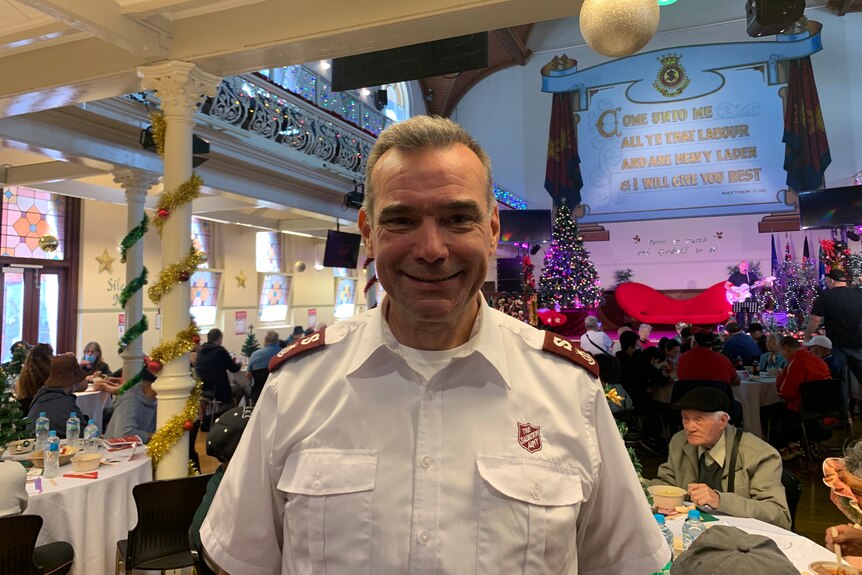 A man in Salvation Army uniform at a Christmas party.