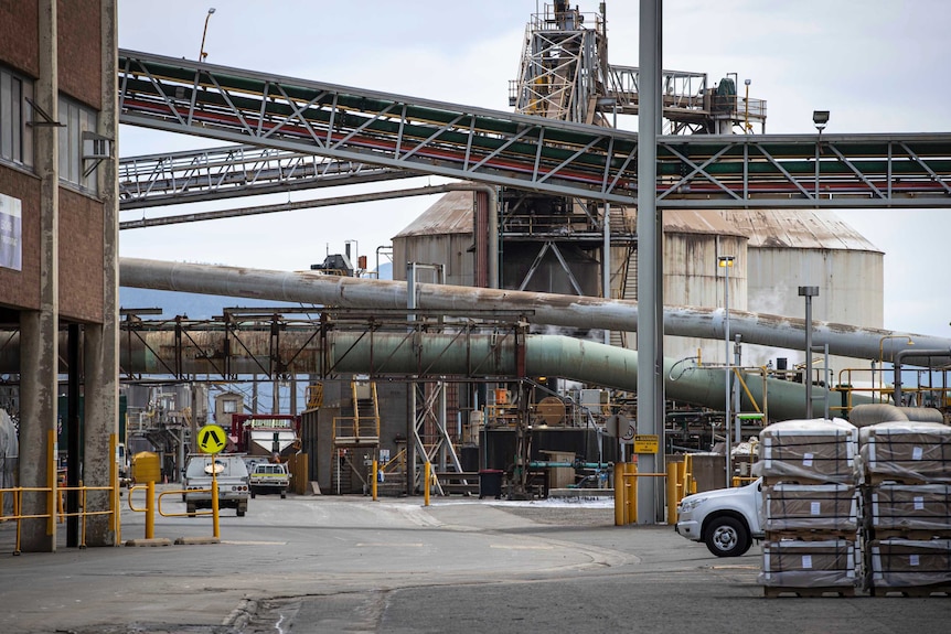 Rusty pipes and conveyor belts at a zinc smelter