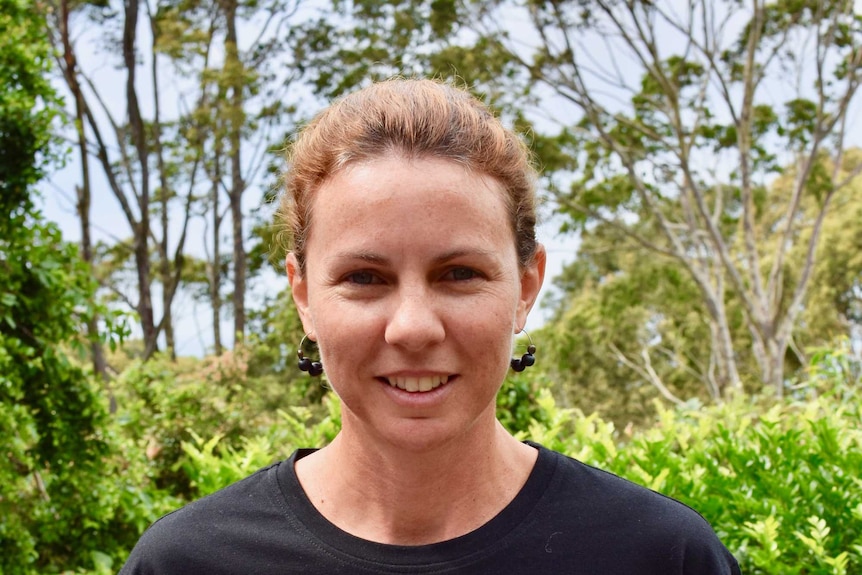 Rachel Theodore holds sea urchins packaged in containers for eating