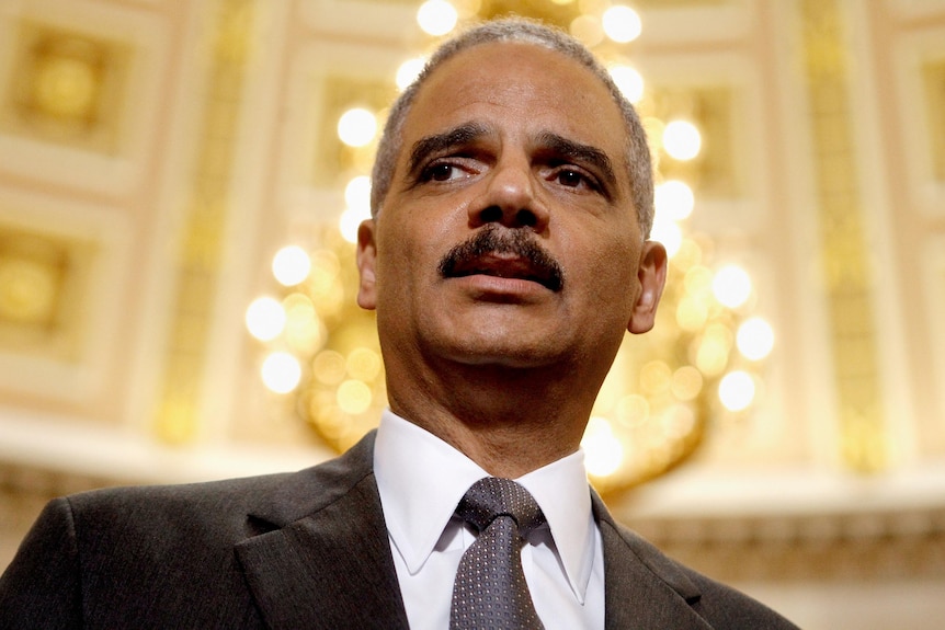 Eric Holder talks to reporters after meeting with Darrell Issa.