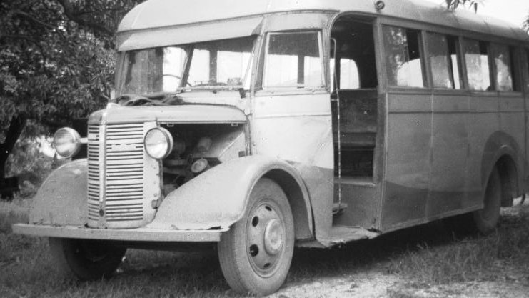 Black and white photo of a beaten up young's bus 