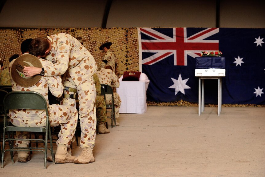 Soldiers console each other