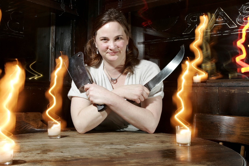 Julie Powell poses with two large knives