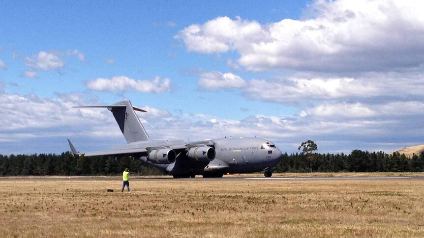A military plane lands at Hobart airport.