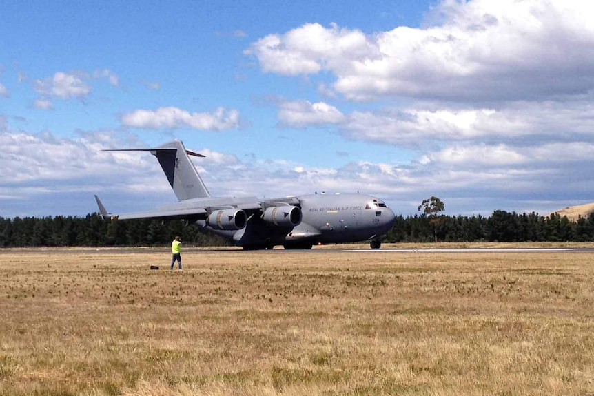 A military plane lands at Hobart airport.