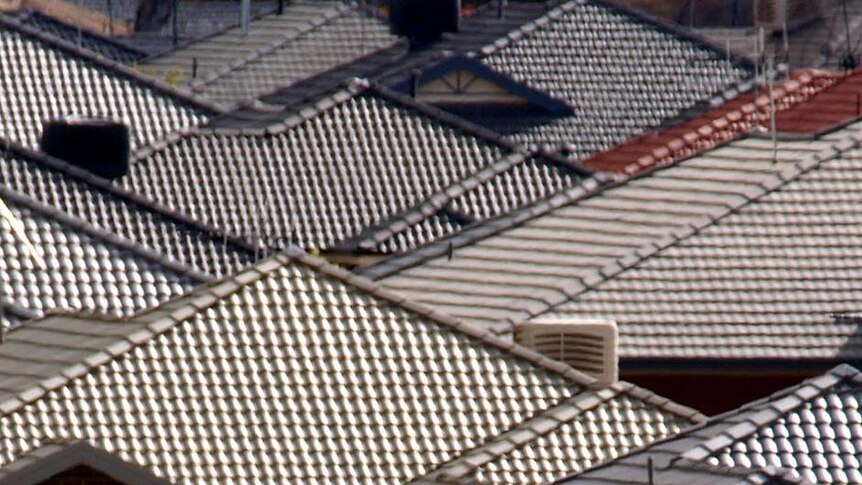 Roofs of houses are covered with different coloured tiles.