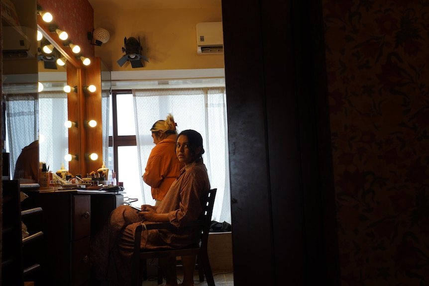 A woman having makeup done.