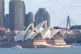 Sydney city skyline with tall buildings, Opera House and Fort Dennison.