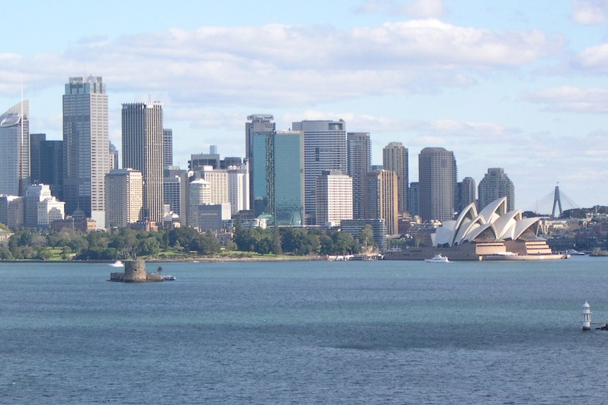 Sydney city skyline with tall buildings, Opera House and Fort Dennison.