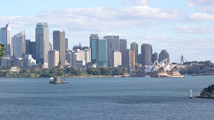 Sydney city skyline with tall buildings, Opera House and Fort Dennison.