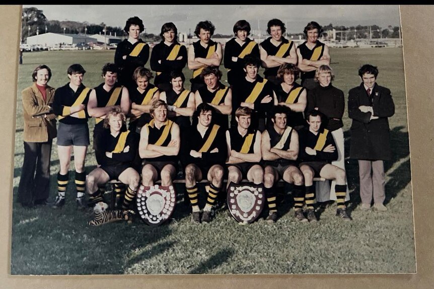 A team of men in yellow and black uniforms.