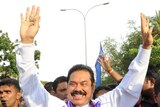 Sri Lankan President Mahinda Rajapakse acknowledges cheers from his supporters