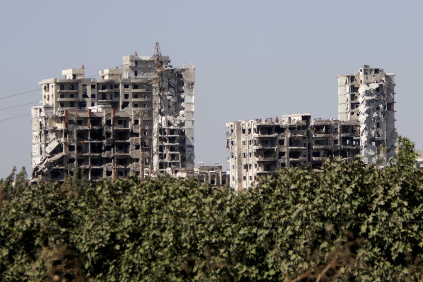 The ruins of tall buildings seen in the distance in Homs.
