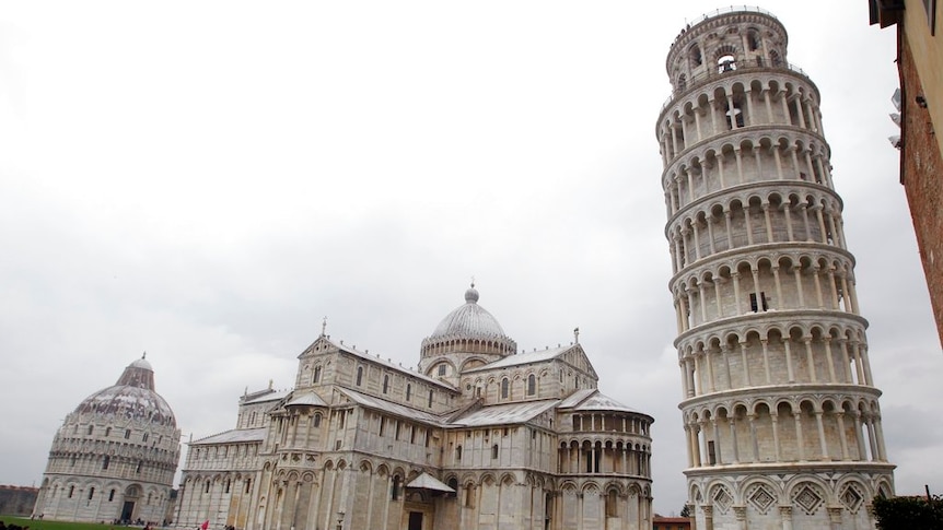 The Leaning Tower of Pisa (Torre di Pisa) is seen at right next to the medieval cathedral of Pisa.