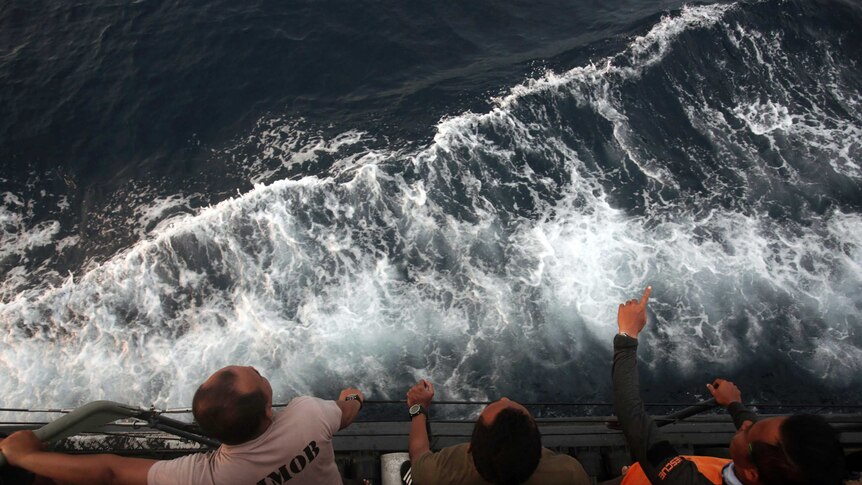 Rescuers scan the horizon over a choppy sea