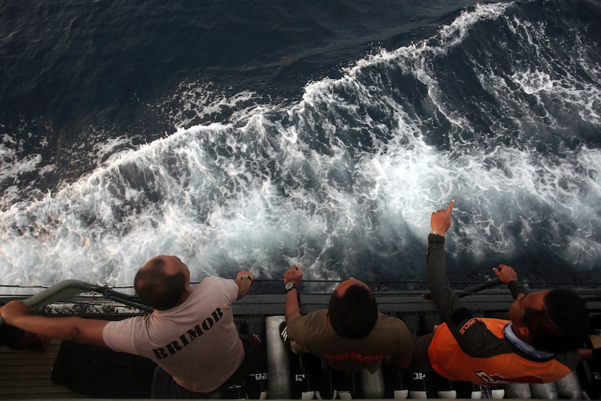 Rescuers scan the horizon over a choppy sea