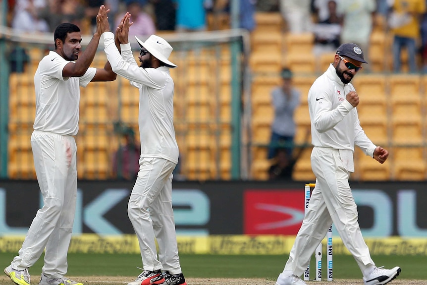India captain Virat Kohli (R) and team-mates celebrate during the victory over Australia in Bangalore.