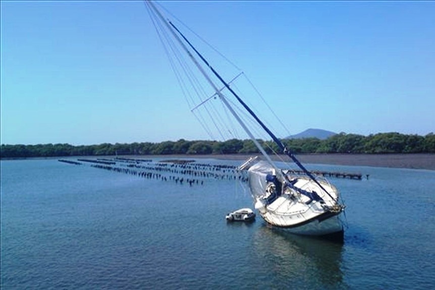 A yacht runs aground in the main channel of the Myall River at Tea Gardens.