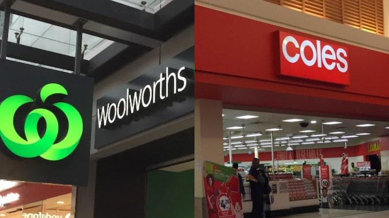 A Woolworths sign next to a Coles sign outside the shops