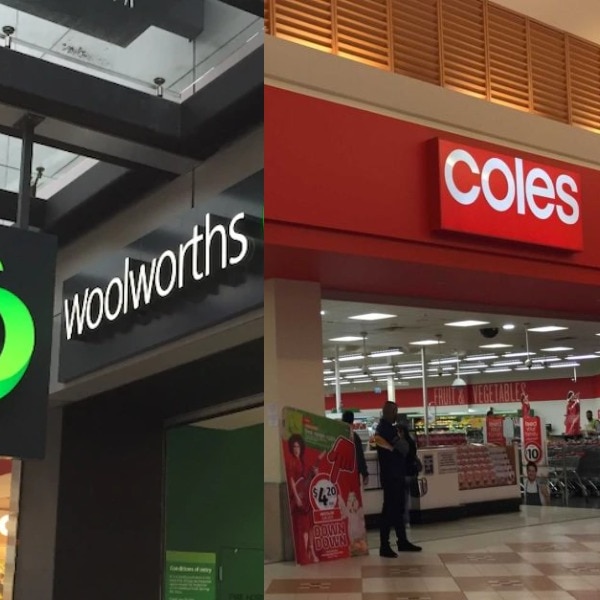 A Woolworths sign next to a Coles sign outside the shops