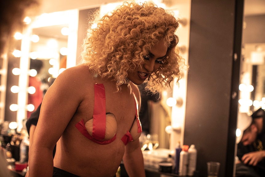 Colour photo of KoCo Carey getting ready in dressing room at Day for Night 2018.